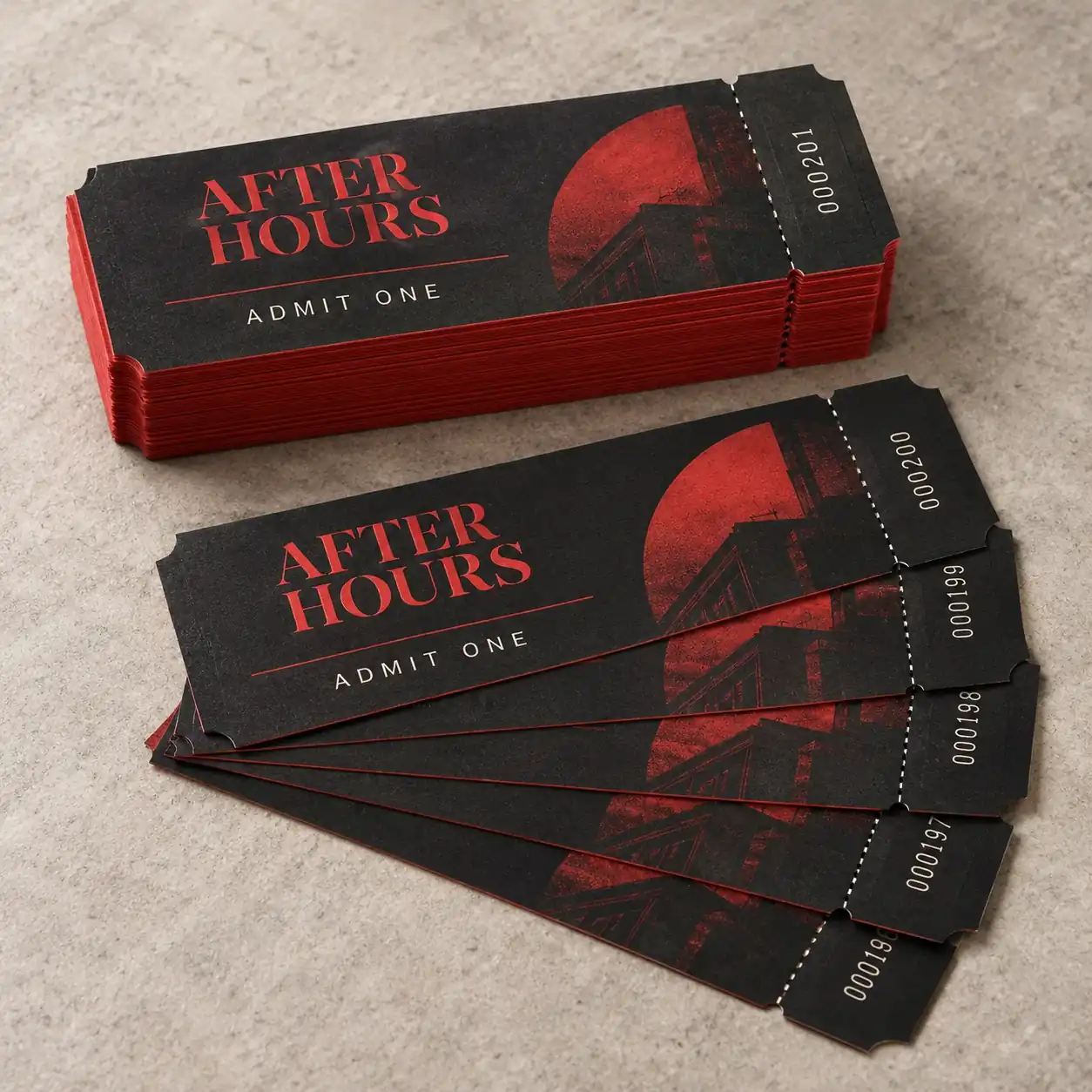 Printed event tickets shown as a physical product in charcoal, red and warm white
