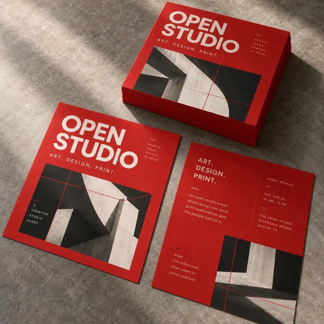 Red, charcoal and warm-white Open Studio flyers printed on textured paper