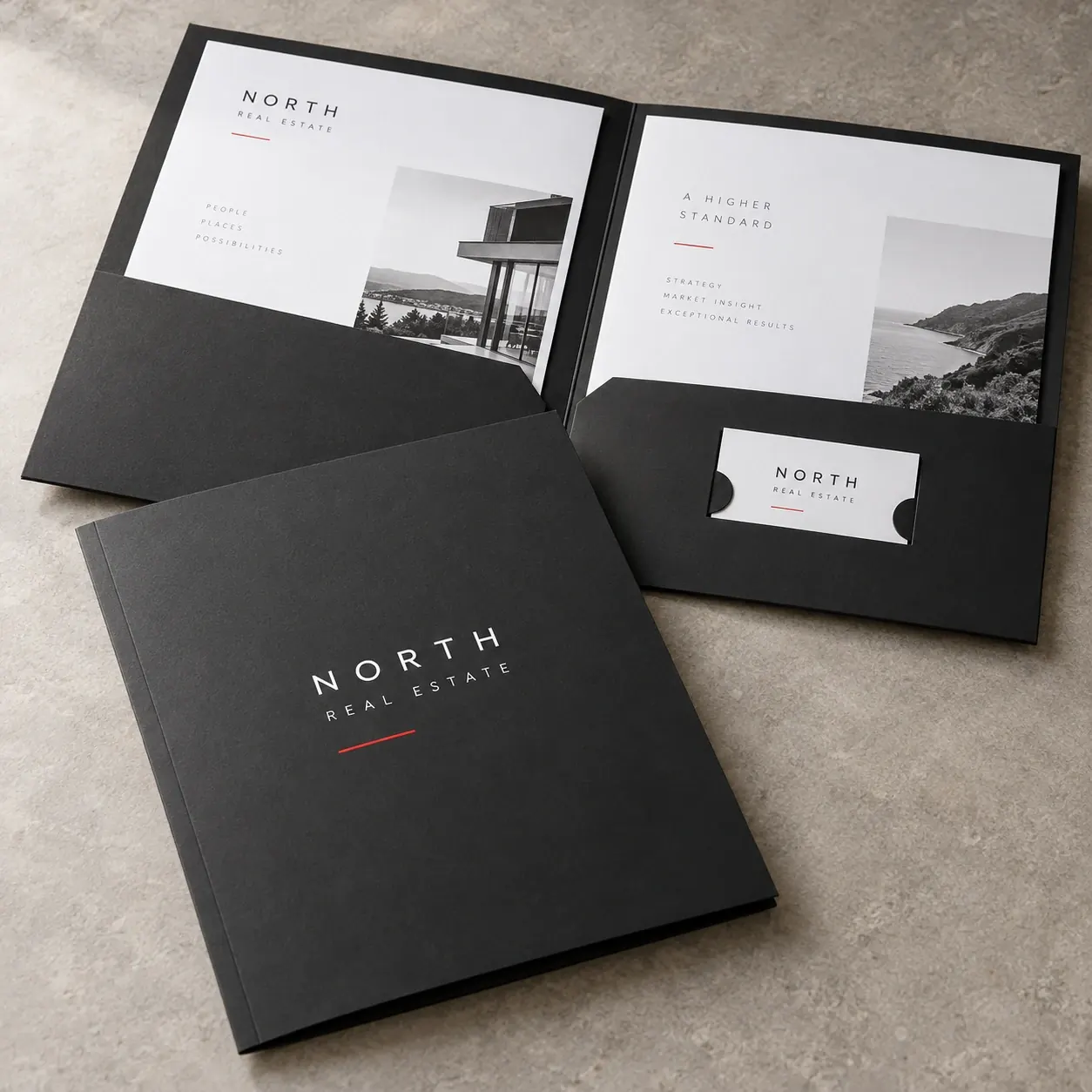 Printed presentation folders shown as a physical product in charcoal, red and warm white