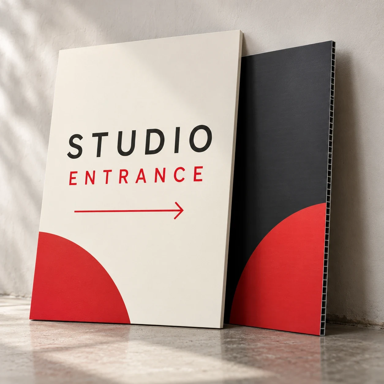 Printed rigid signs shown as a physical product in charcoal, red and warm white