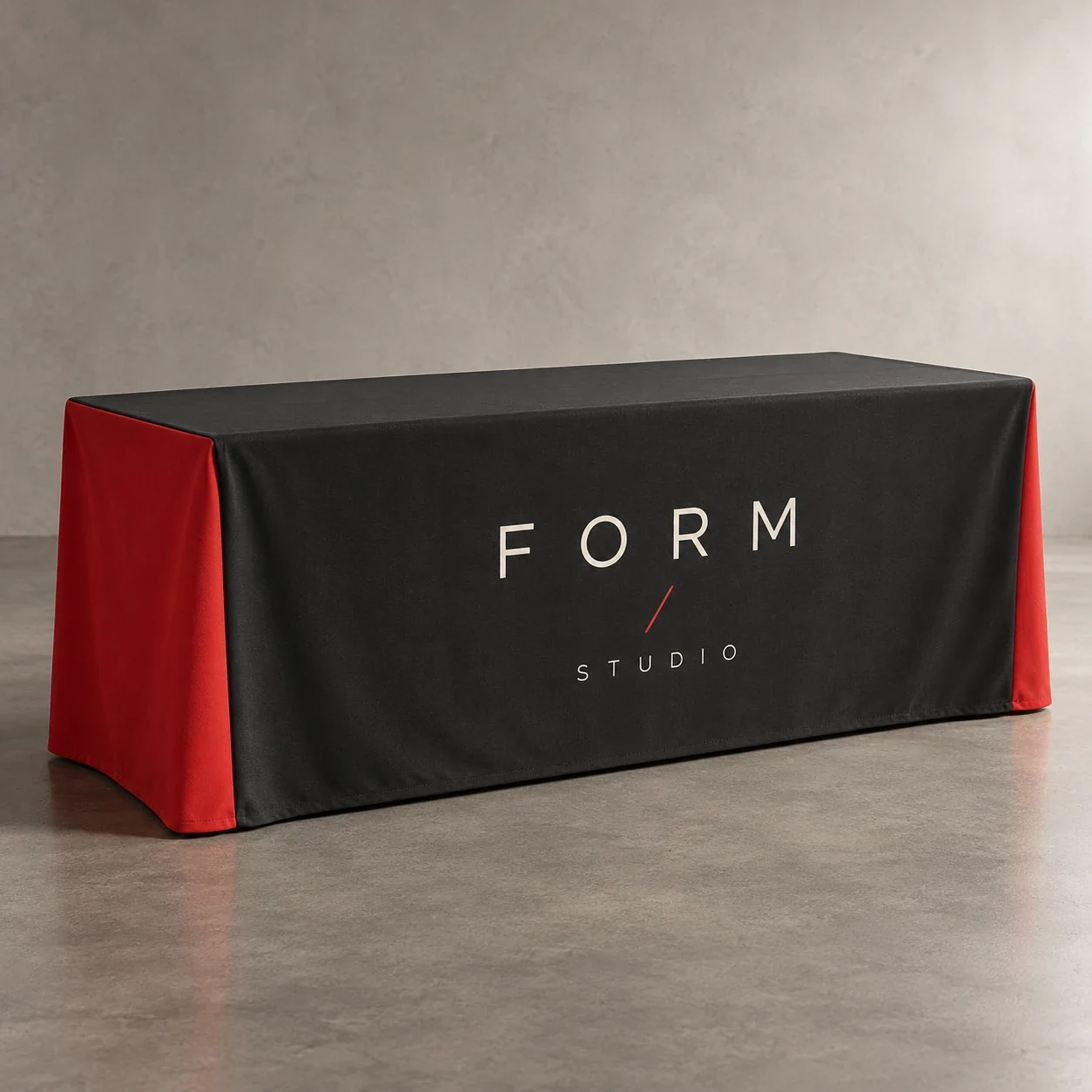 Printed table covers shown as a physical product in charcoal, red and warm white